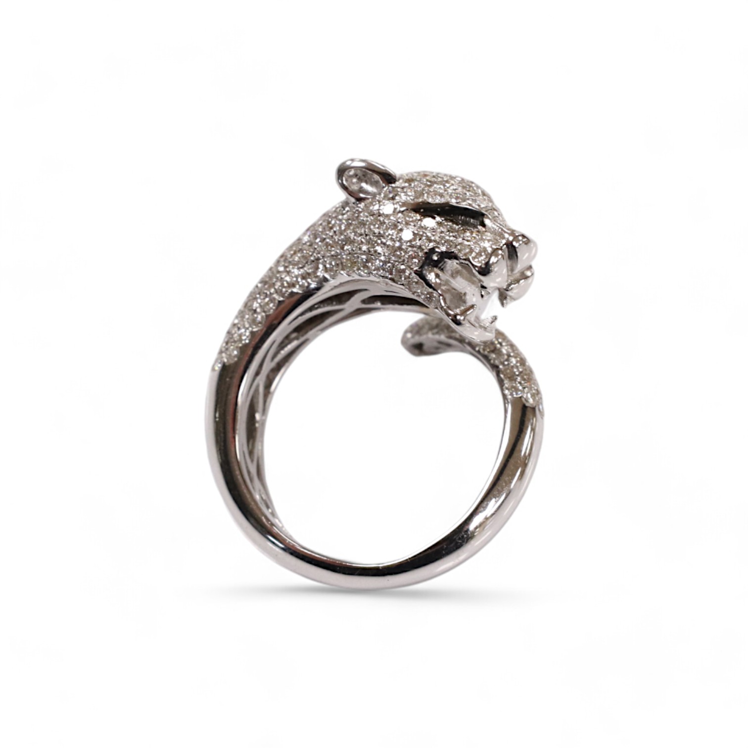 A modern Cartier style 18k white metal and pave set diamond chip dress ring, modelled as the head and tail of a leopard, size M, gross 9 grams. Condition - good